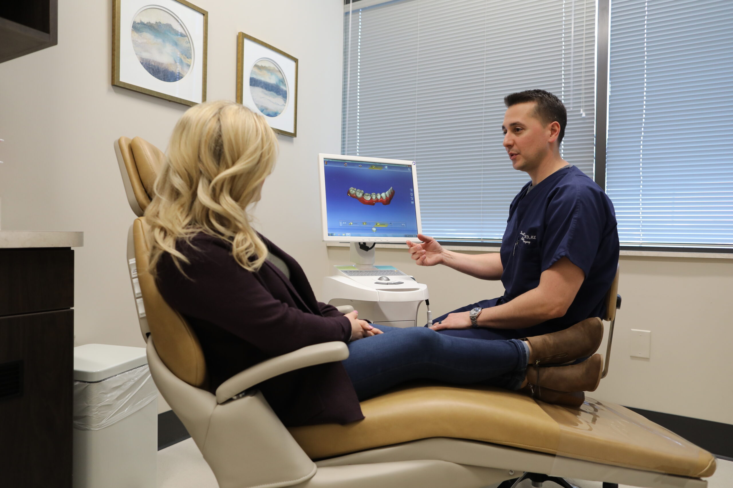 Oral Surgeon looking at dental imaging for patient