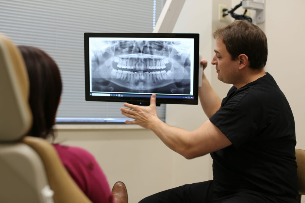 Oral Surgeon showing patient x-rays